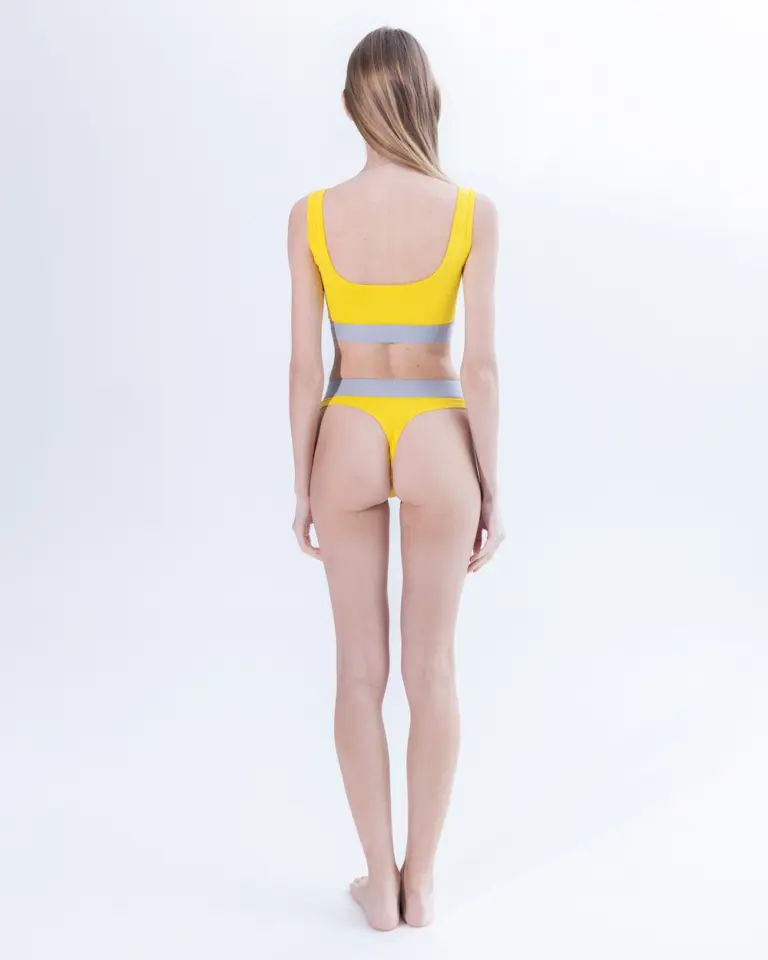 Жіночі жовті стрінги з бавовни Intelligent Organism на моделі, вигляд ззаду